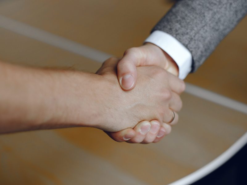 Close-up image of a firm handshake. Man standing for a trusted partnership.